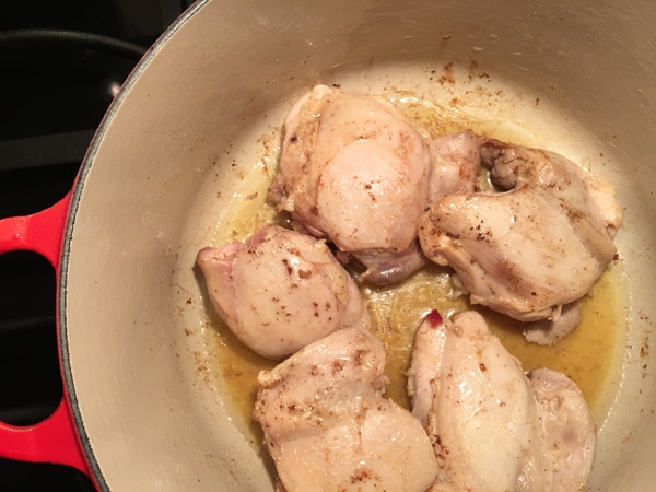 Chicken browning in the bottom of a pan