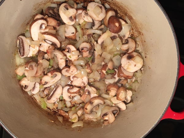 Onions and mushrooms added to the pan to be saut&eacute;ed