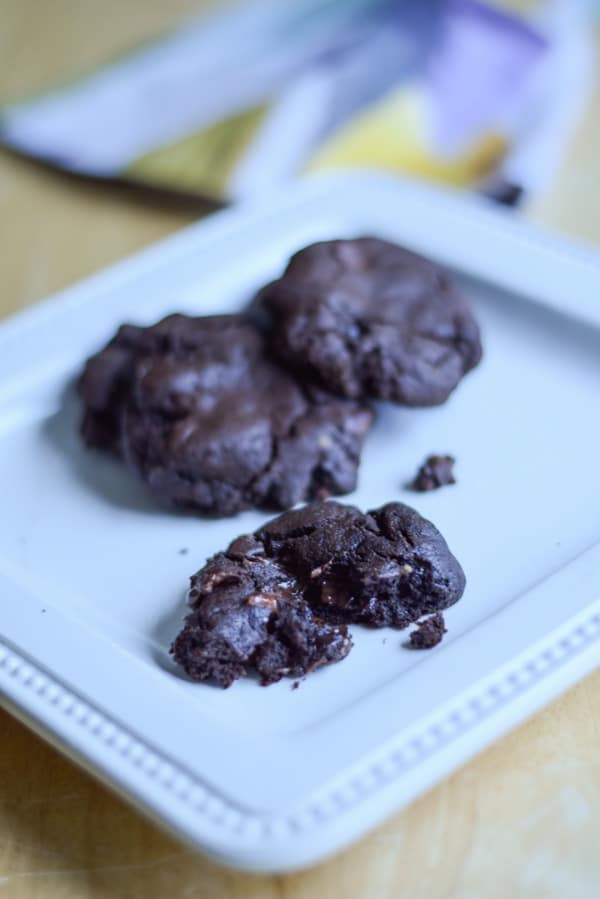 A white square plate with chocolate cookies on it
