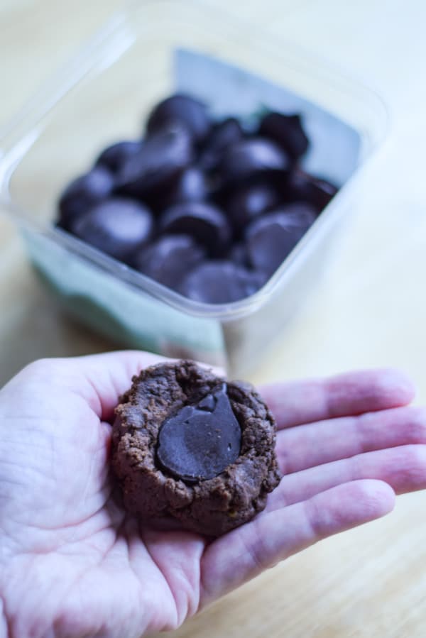 A hand with cookie dough and a mint in the middle