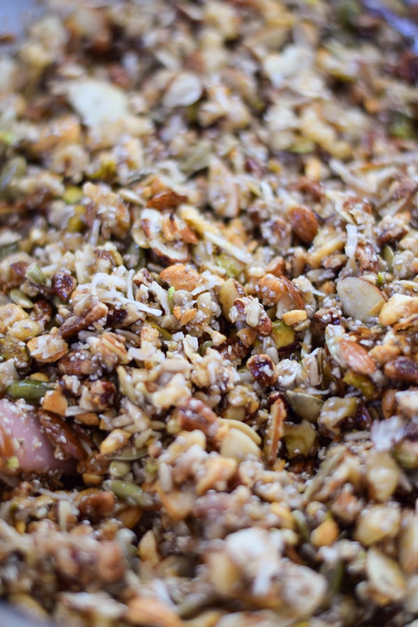 Partially baked granola mixture after the maple syrup coconut oil mixture has been added.