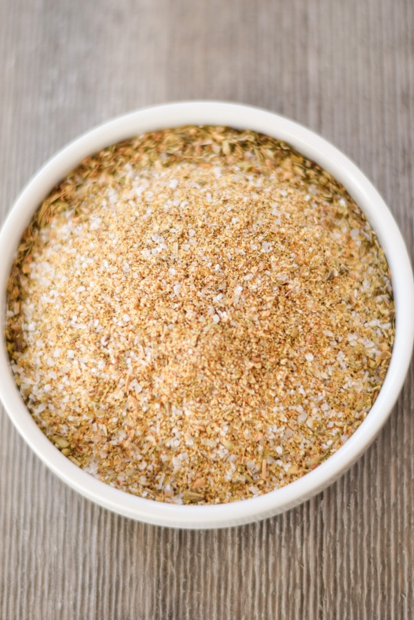 Close up of herbs and spices mixed in a small white dish