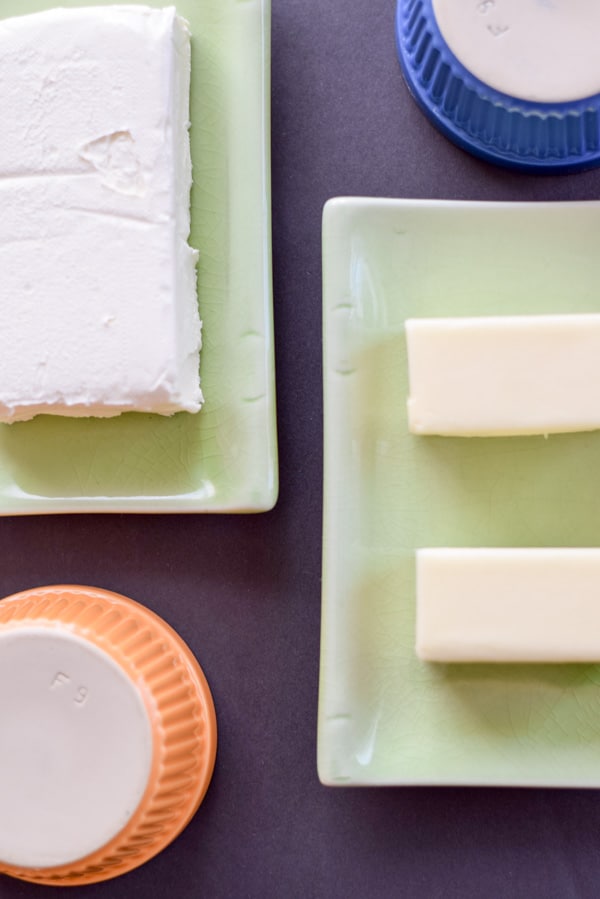 Cream cheese and butter on two small rectangle plaates