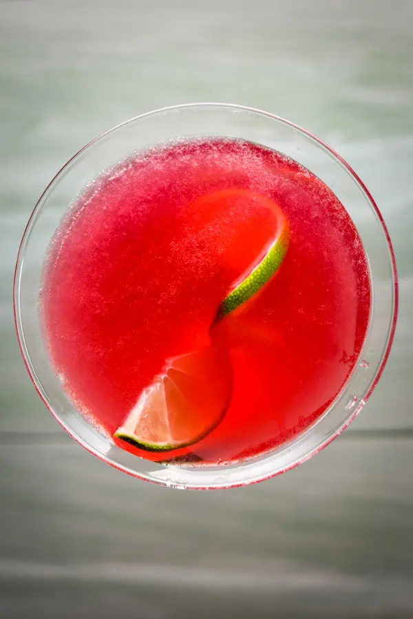 Overhead view of the red drink with lime in it