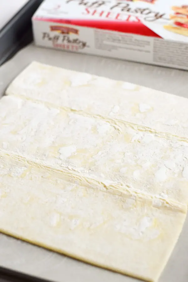 Puff pastry unrolled and placed on a pan with parchment paper