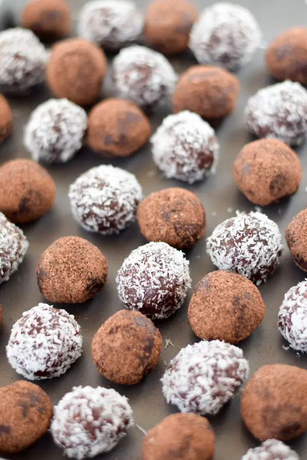 Rum balls lined up on a pan ready to be eaten