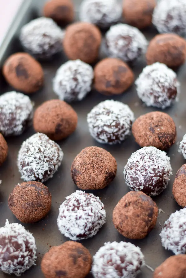 Pan of cocoa powder and coconut  rolled rum balls