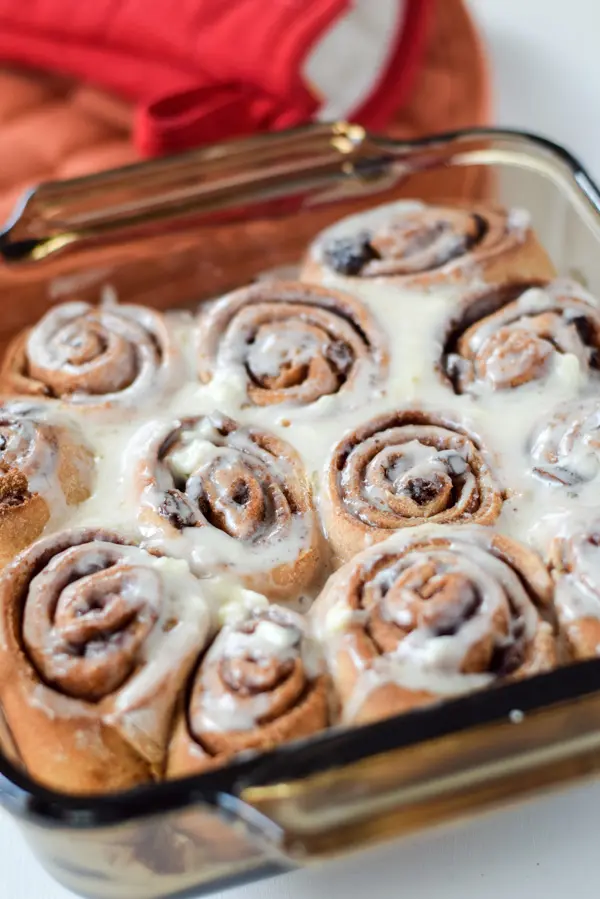 The cinnamon roll iced and still in the pan