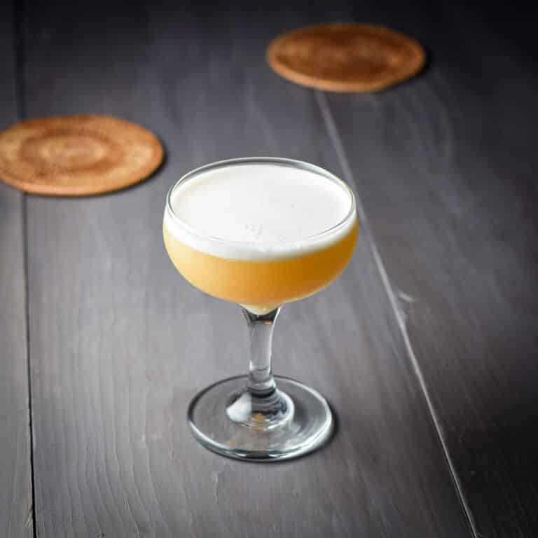 The pretty foamy amber cocktail in a coupe glass - square