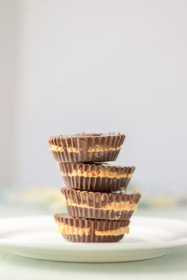 Vertical view of a stack of peanut butter cups on a white plate