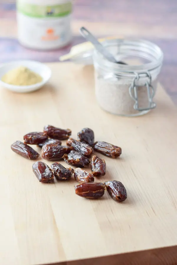 Dates, chia seeds, flax meal and maple syrup on a table