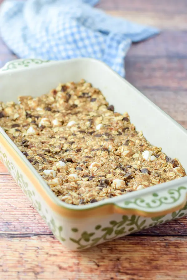 The granola bars packed into a baking dish ready to be baked