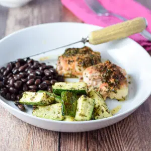 Zucchini, chicken and black beans on a plate - square