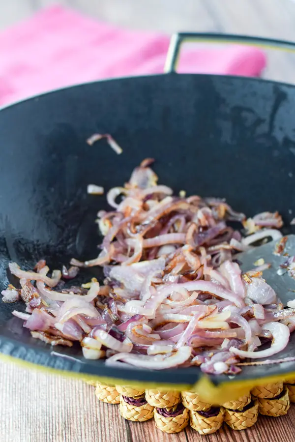 Red onion sautéed in a wok