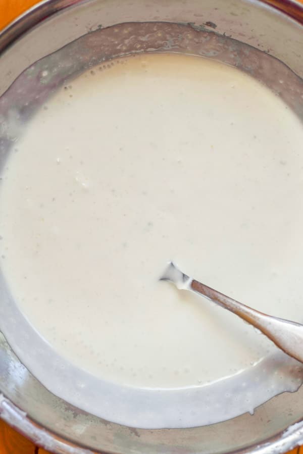 All the ingredients mixed in a metal bowl for the dressing
