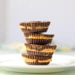 Vertical view of a stack of peanut butter cups on a white plate - square