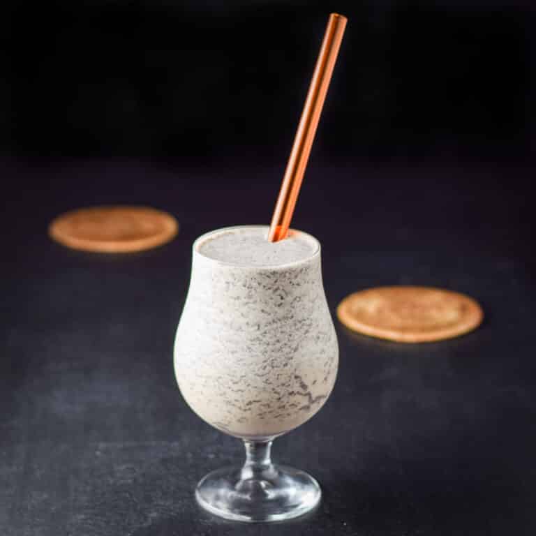 A straw sticking out of a tulip glass filled with the frozen drink - square