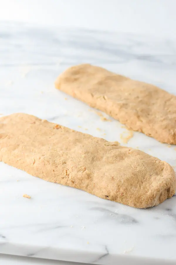 Two long rectangles of scone dough on a marble slab