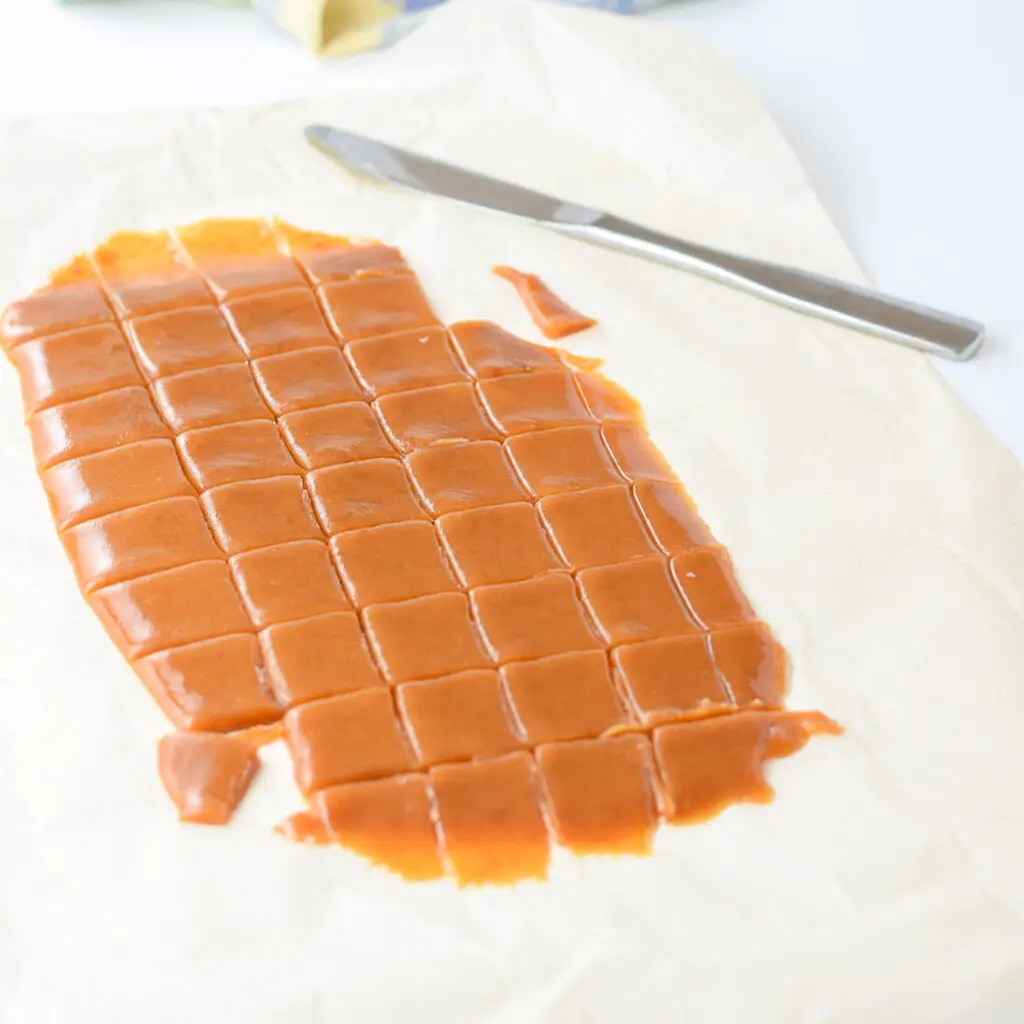 Cut caramels on parchment paper