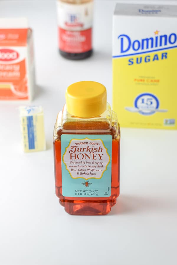 Honey, butter, cream, vanilla and sugar on a table