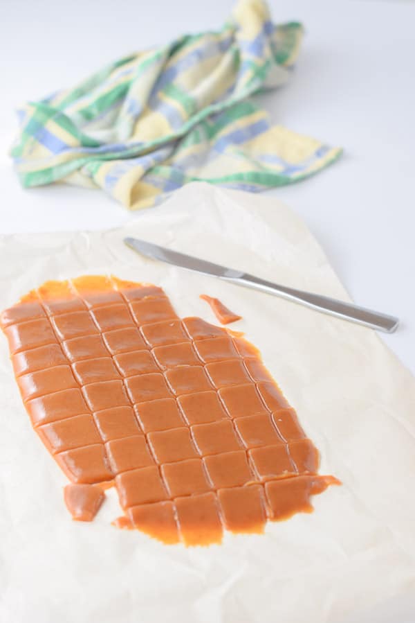 caramel poured on parchment paper and cut