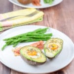 Plated healthy eggs nestled in avocado ready to eat