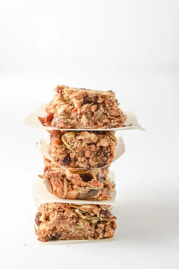 Vertical view of four stacked granola bars with a white background