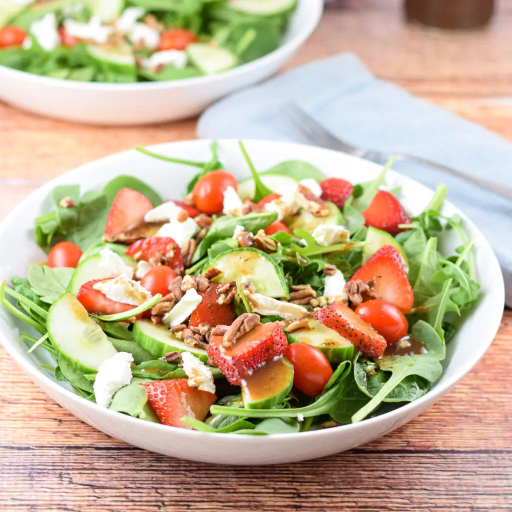 The beautiful strawberry pecan salad with balsamic dressing on top