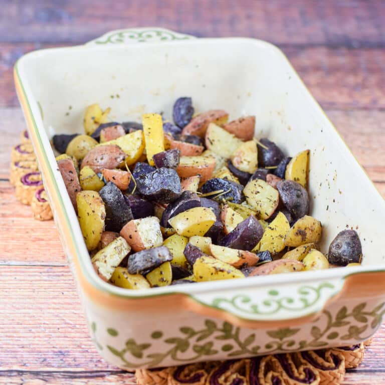 A baking dish with the potatoes roasted in it fresh out of the oven - square