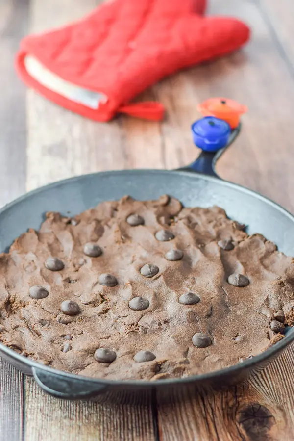 Dough into a skillet with some chocolate chips on top