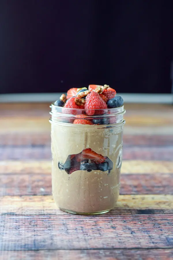 Vertical view of the jar of layered chocolate oat, fruit and nuts