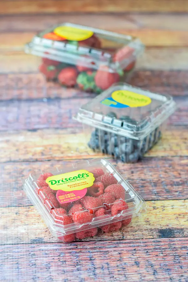 Raspberries, blueberries and strawberries in their plastic containers