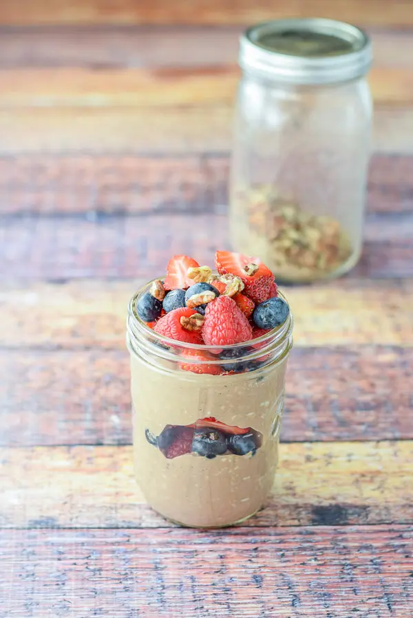 More berries and walnuts on top heaped in the overnight oats