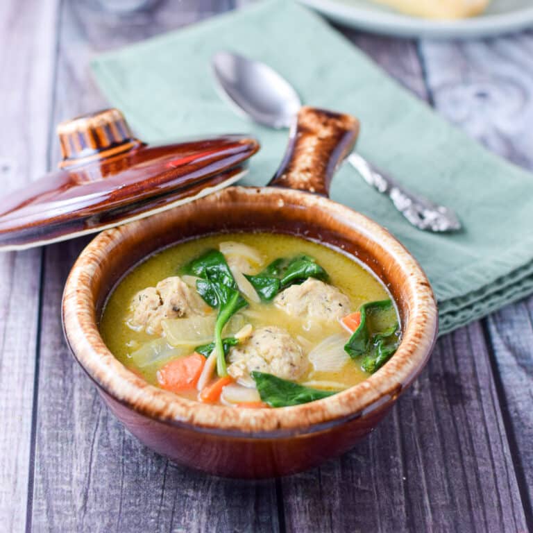 Two brown crocks filled with the meatball soup - square