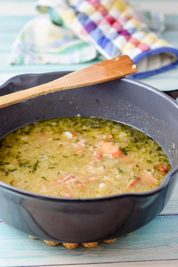 Lobster added to the pan of broth and vegetables