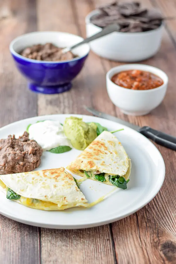 super tasty mushroom and spinach quesadillas cut in half and ready to eat