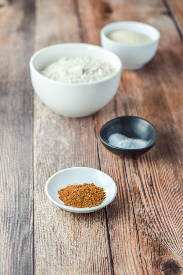 Cinnamon, baking soda, flour and sugar on a wooden table