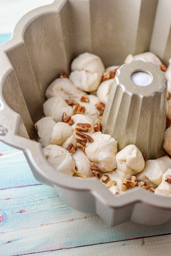 Pecans sprinkled on the dough in the bundt pan