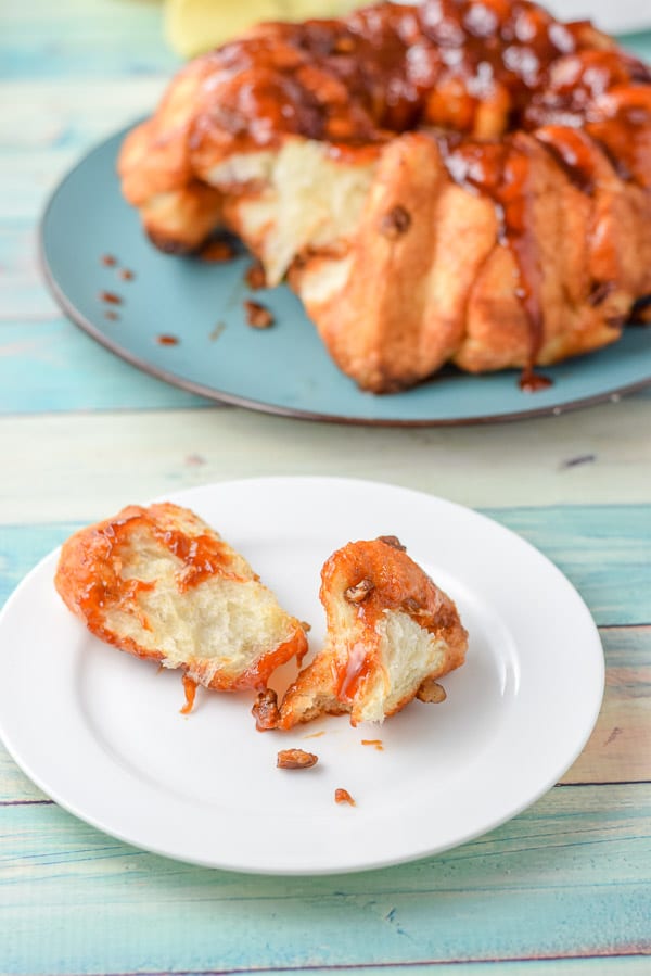 A few pieces torn off bread with butterscotch topping and nuts