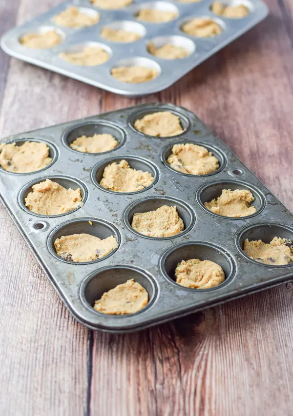 Batter pressed down in the muffin tins