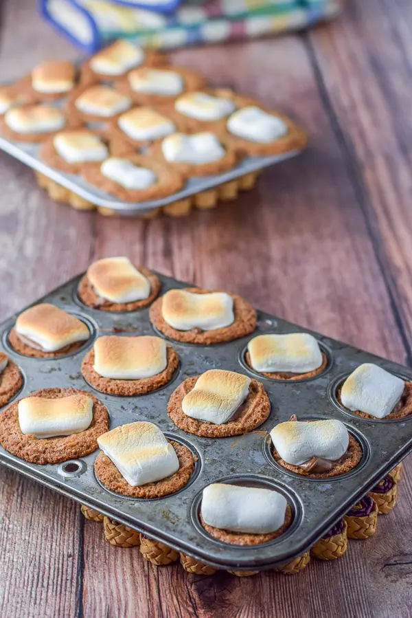 Marshmallows all toasted on the cookies in the muffin tins