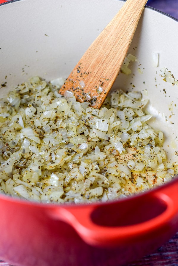 Diced onion and herbs sautéd in a red Dutch oven