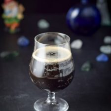 A curved beer glass filled with the Guinness cocktail