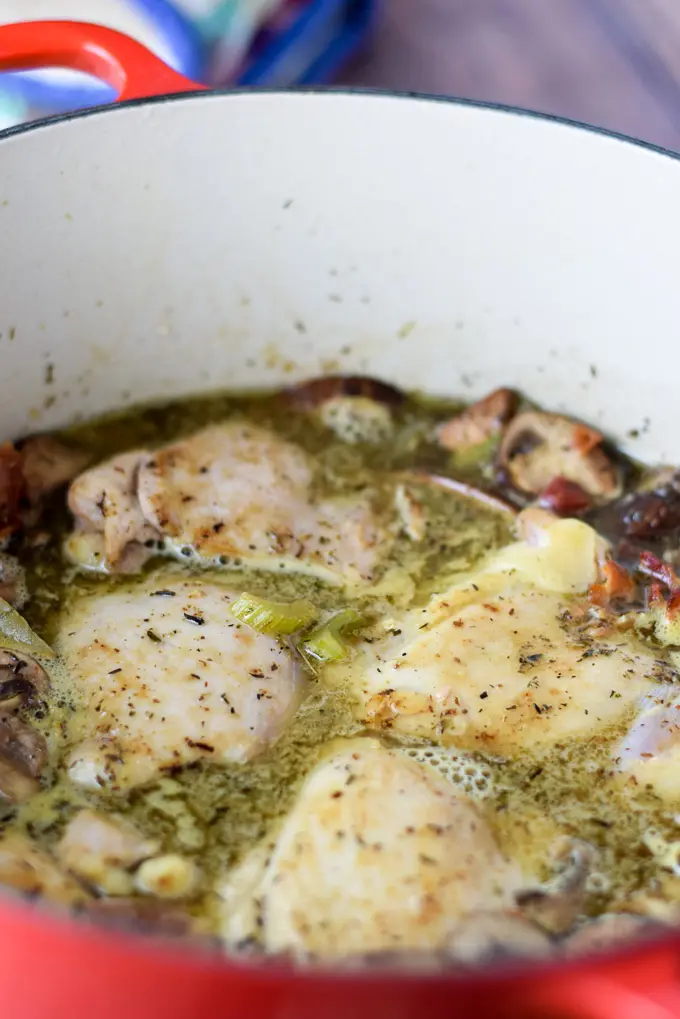 Chicken back in the pan with the chicken broth and wine