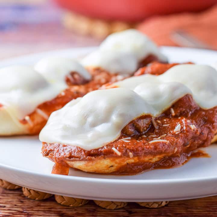 Vertical view of the bread with sauce, meatballs and melted cheese with a pan in the background - square