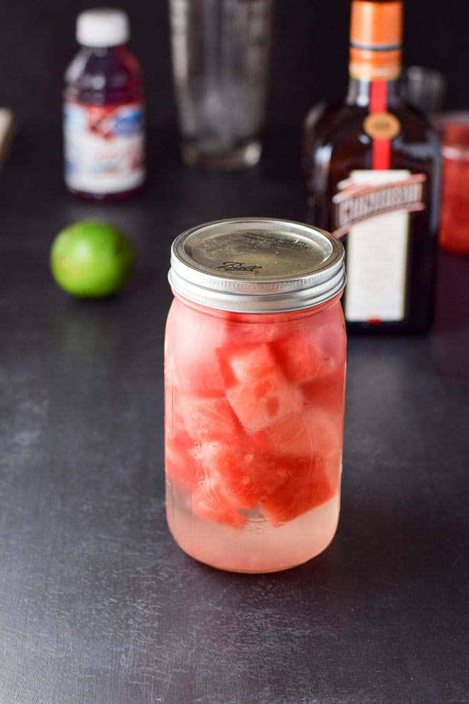 Watermelon infused vodka, Cointreau, lime, cranberry juice and simple syrup on a black board