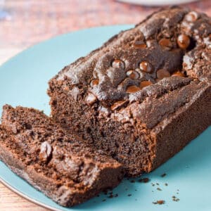 A blue plate with sliced chocolate bread - square