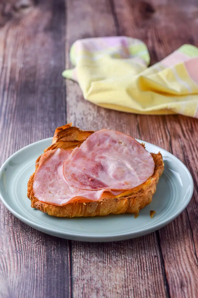 Sautéd ham on the croissant with a napkin in the background