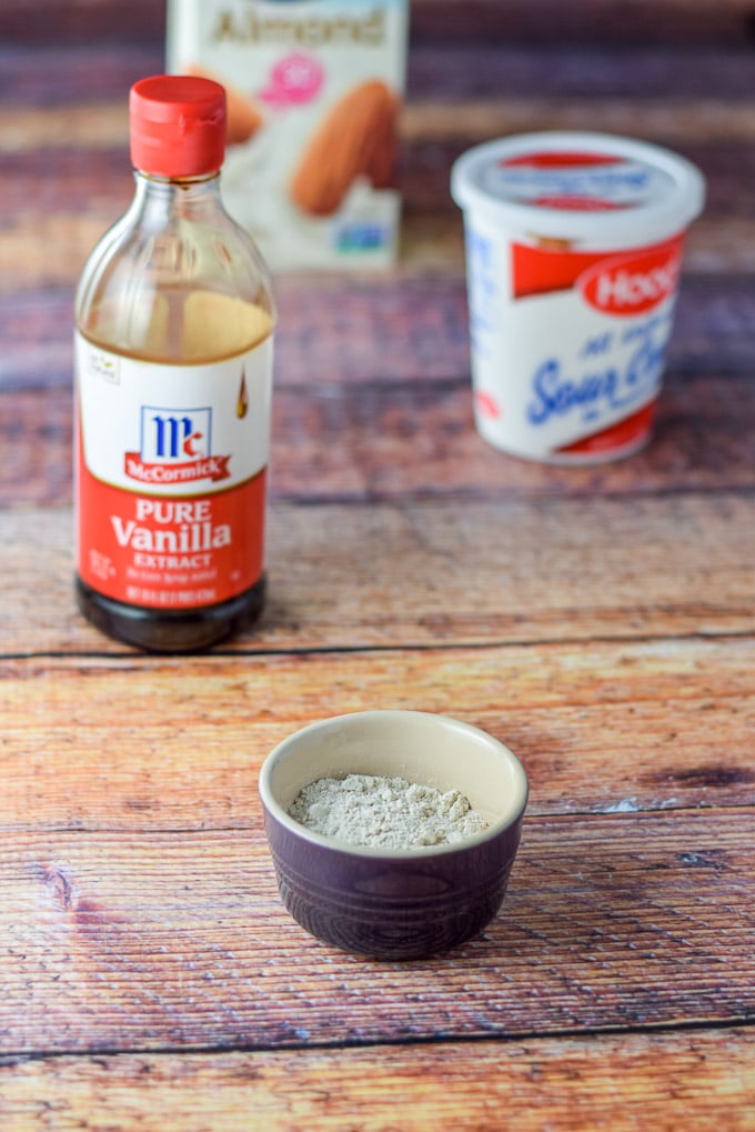 Flour, vanilla, sour cream and milk on the table