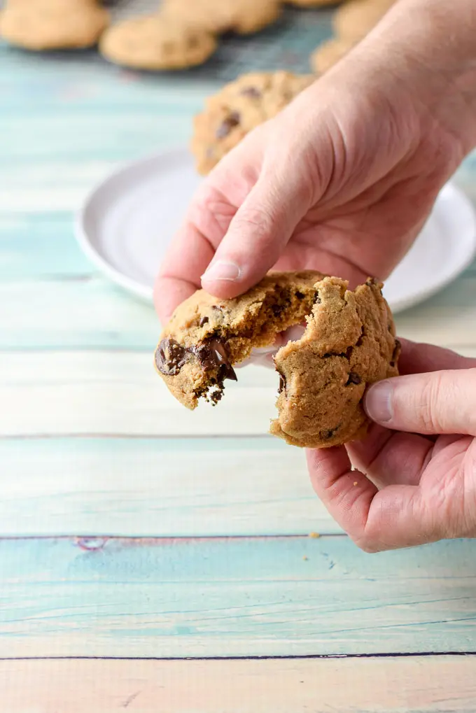 The male hand pulling apart a cookie